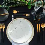 Black and gold color Luxury table set for Wedding reception in barn